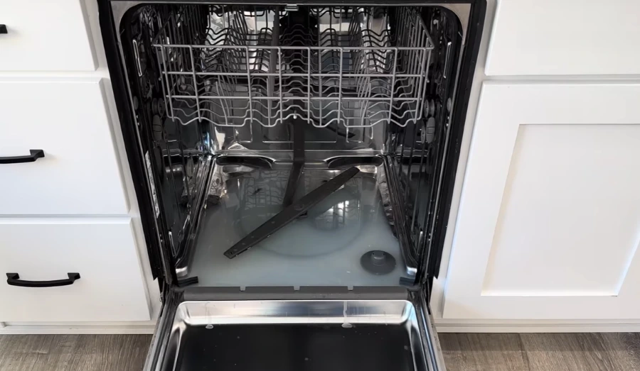 Standing water in the bottom of a dishwasher with the lower spray arm removed